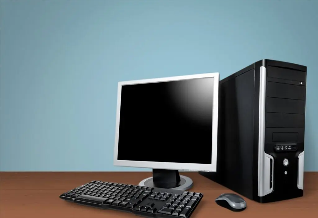 Desktop computer setup with monitor, keyboard, and CPU, representing electronics at risk of pest damage such as rodents or insects