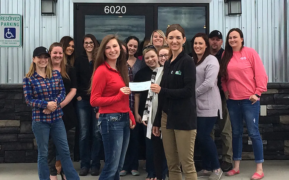 Group photo of a team presenting a check during a community or charity event