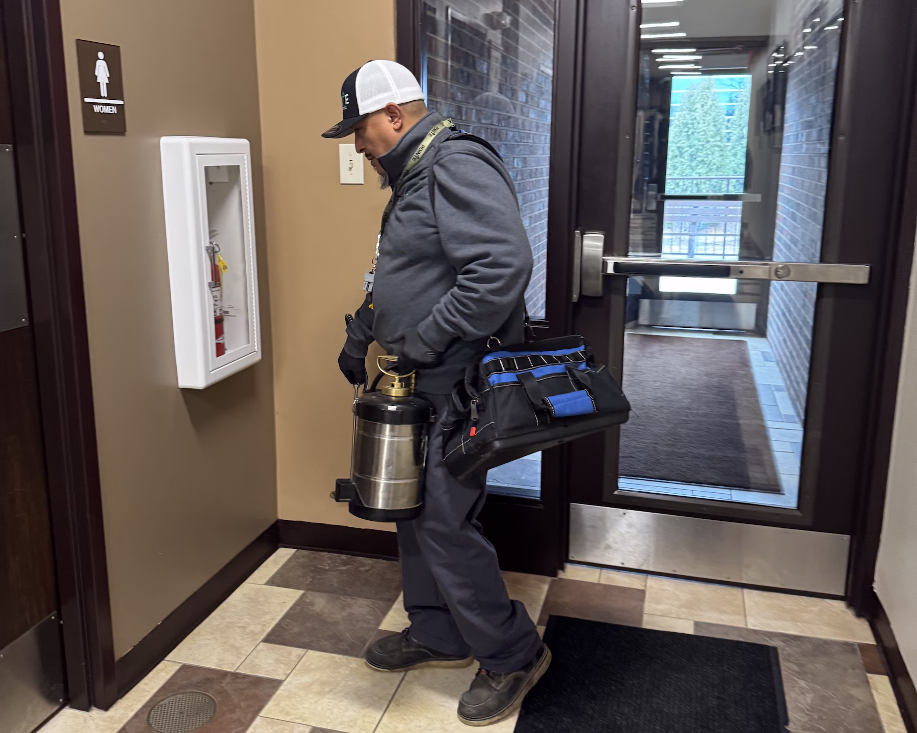 Pointe pest control technician working in an office building